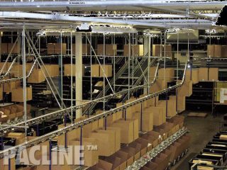 Multiple shipping cartons are being conveyed over produce packing line on a single tier tray carrier.