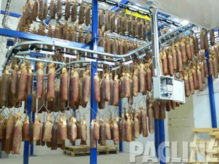 Sausages stored on overhead conveyor. Drip trays were used to prevent any contamination of the food product below.