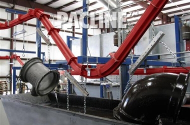 PAC-MAX conveyor can handle sharp inclines to carry these heavy pipe fittings through paint dip line.
