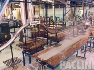 Parts cleaning dip line with tight radius elevation changes to minimize both dip tank size and floor space.