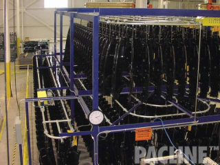 Conveyor system designed with PACLINE&#039;s enclosed track conveyor accumulates unfinished automotive parts.