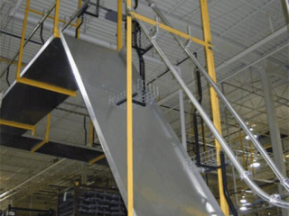 This conveyor accommodates the tight curves and steep elevation requirements to convey automotive water pumps.