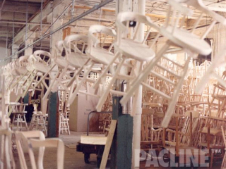 PACLINE overhead conveyor system designed to transport chairs/bar stools through furniture manufacturer.