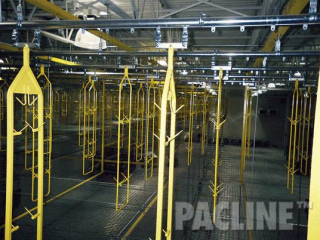 Work in process conveyor system with hundreds of carriers used to carry foam auto seats.