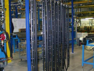 Power assisted manual conveyor uses PAC-LINE&#039;s overhead track and chain system for parts accumulation.