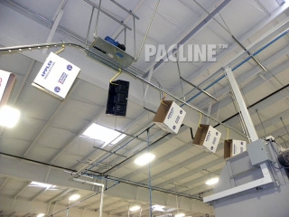 Conveyor installed in ceiling area of produce packing shed.