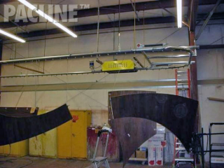 Large custom counter tops are moved through paint line process on Pacline overhead conveyor.