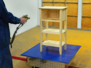 Towline conveyor cart has rotating top to allow access to all sides of furniture during paint finishing process.